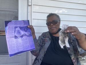 Jannie Bazemore holds up a wipe covered in coal dust from her porch in one hand, and a photograph of her mother doing the same thing 40 years earlier in the other. Dated May 1, 2025.